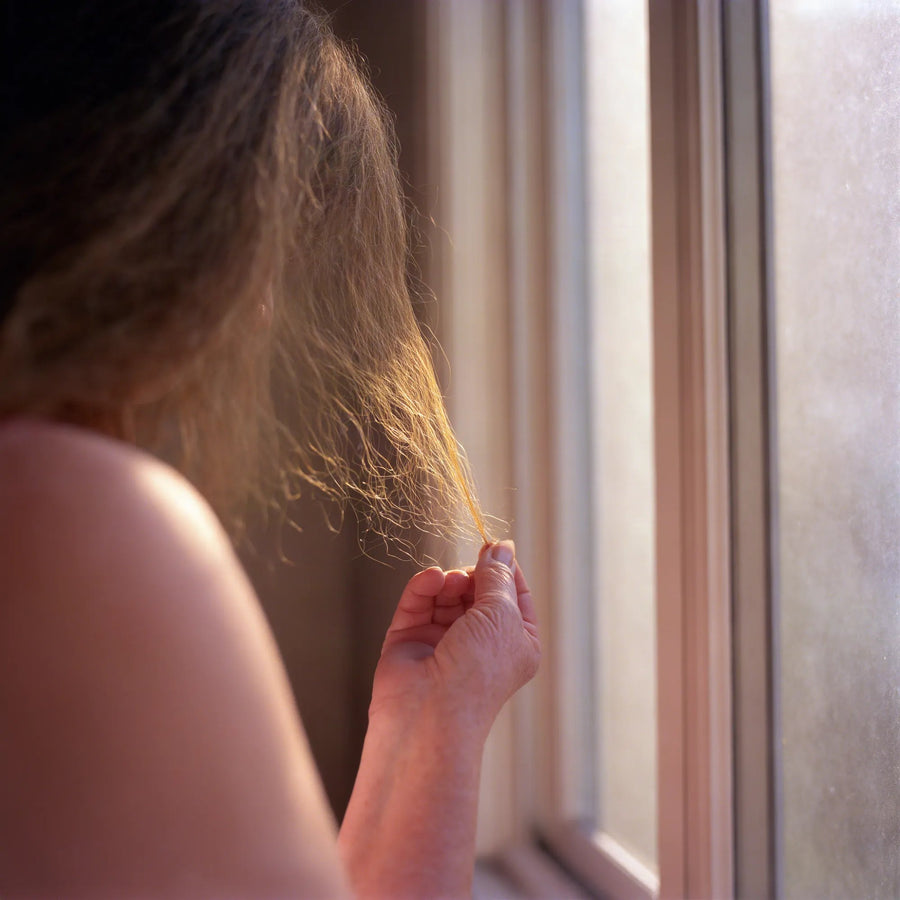 Holding it up to the window.